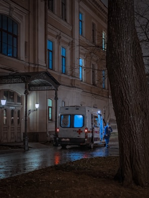 A medical courier vehicle parked outside a hospital.