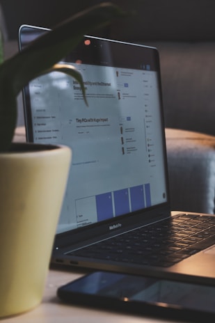 white ceramic mug on black laptop computer