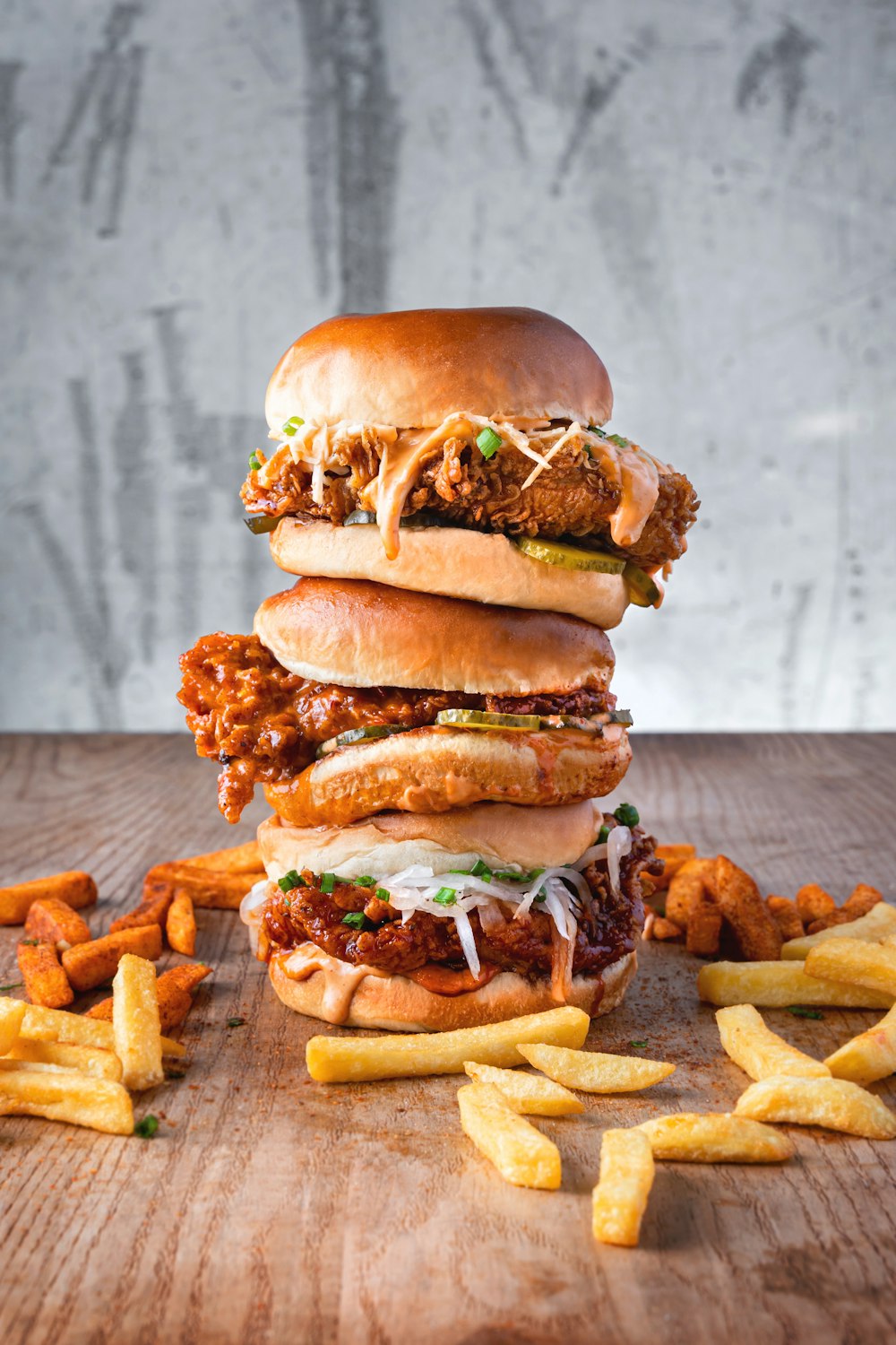 burger with lettuce and fries on brown wooden table