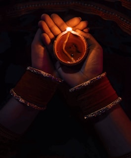 person holding brown ceramic mug with coffee