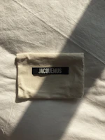 Minimalist aroma pouch resting on a beige linen cloth with gentle sunlight.