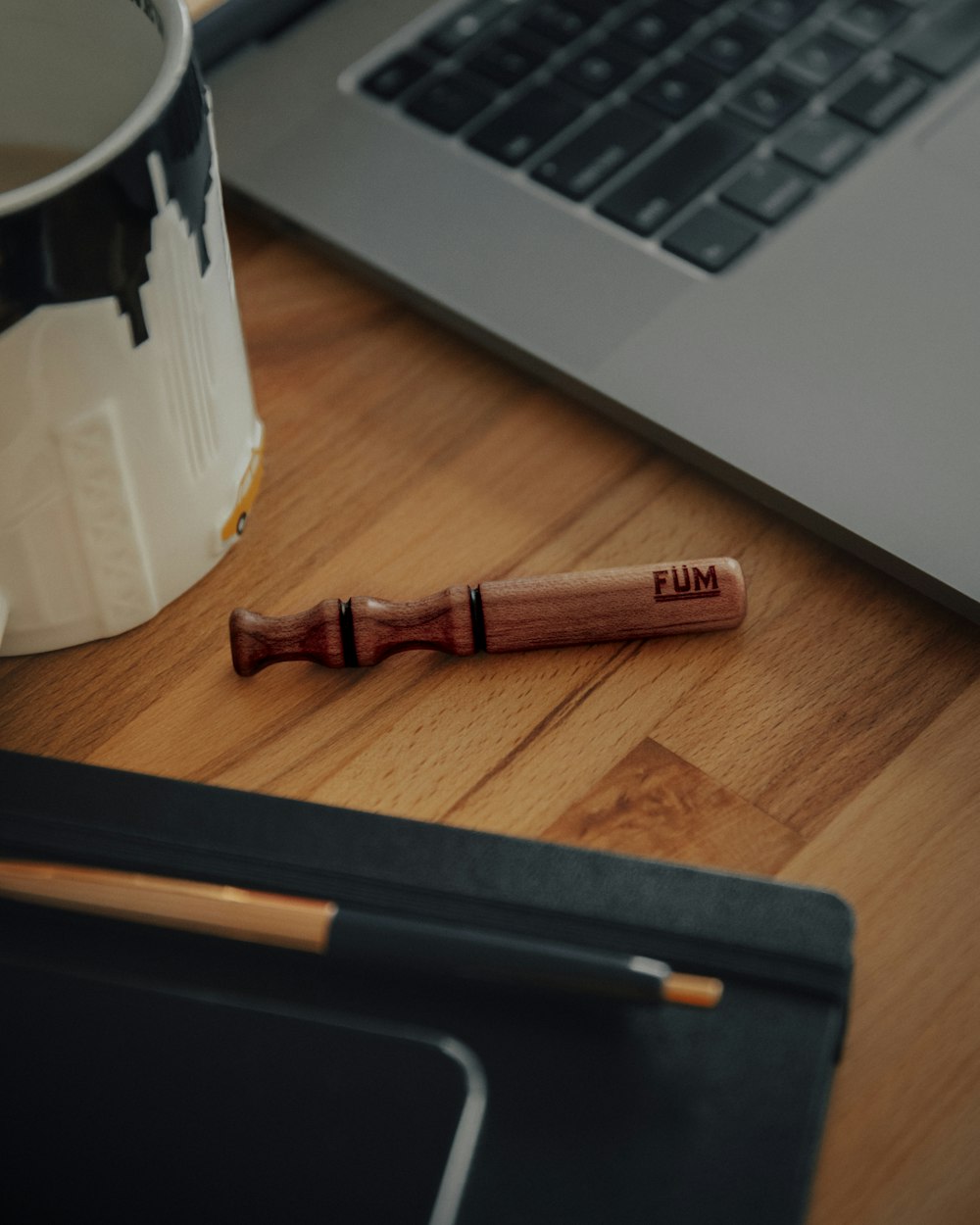 red and black pen beside gray laptop computer