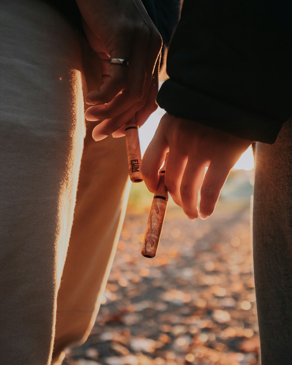 person holding brown wooden stick