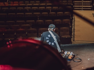 Technician assisting musicians with soundcheck in a cozy live venue.