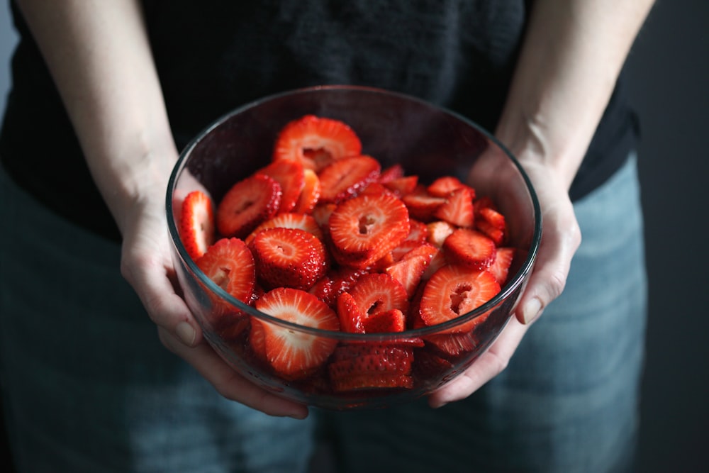 strawberries in clear glass bowl