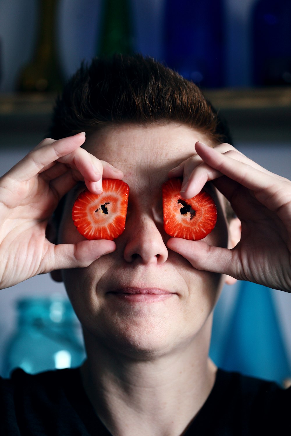 person holding two orange fruits