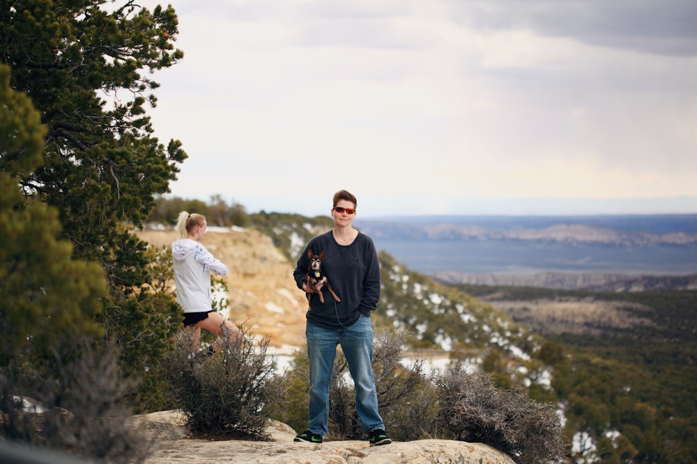 man in black crew neck t-shirt standing beside woman in white t-shirt during daytime