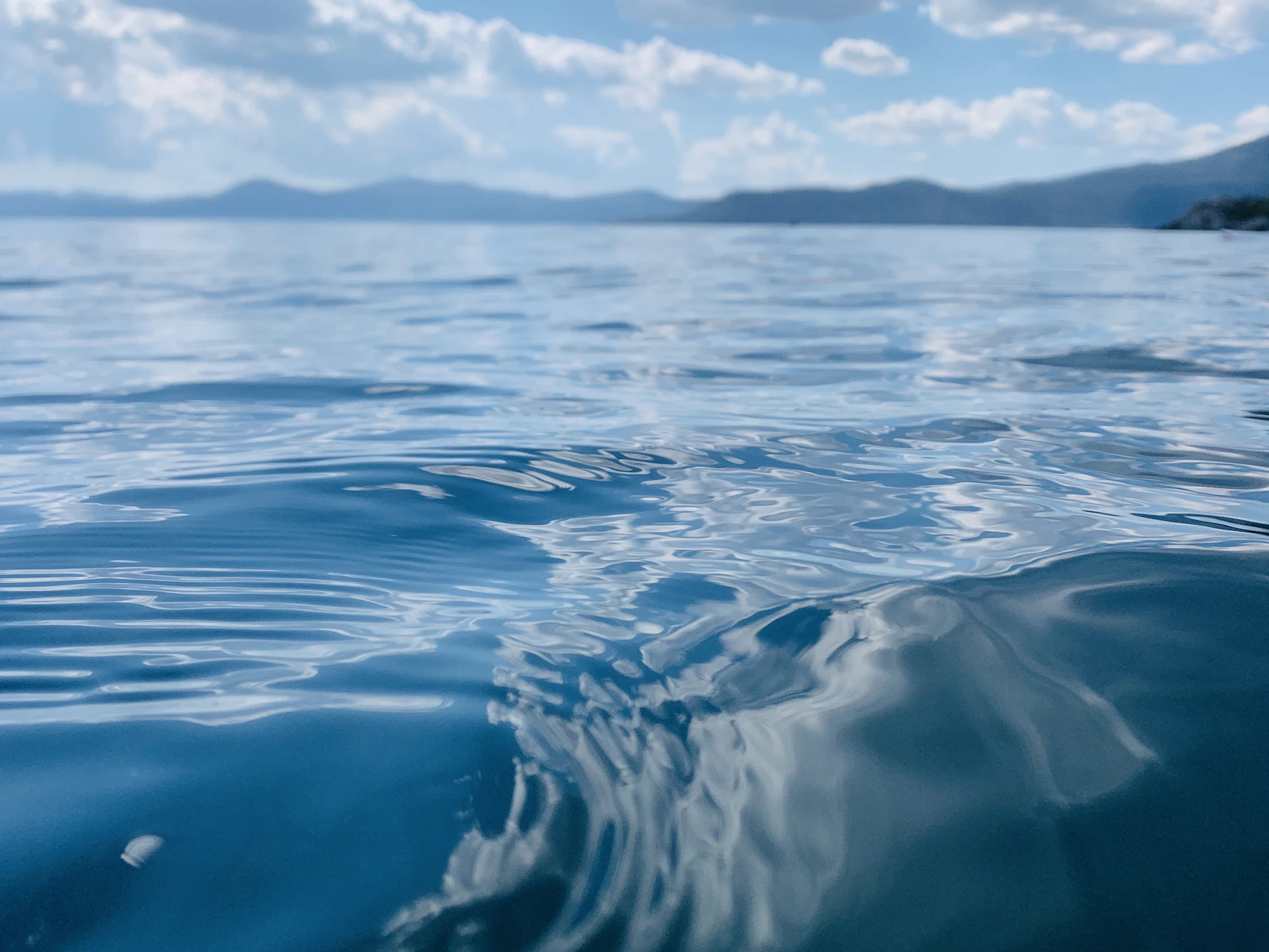 water wave under blue sky during daytime