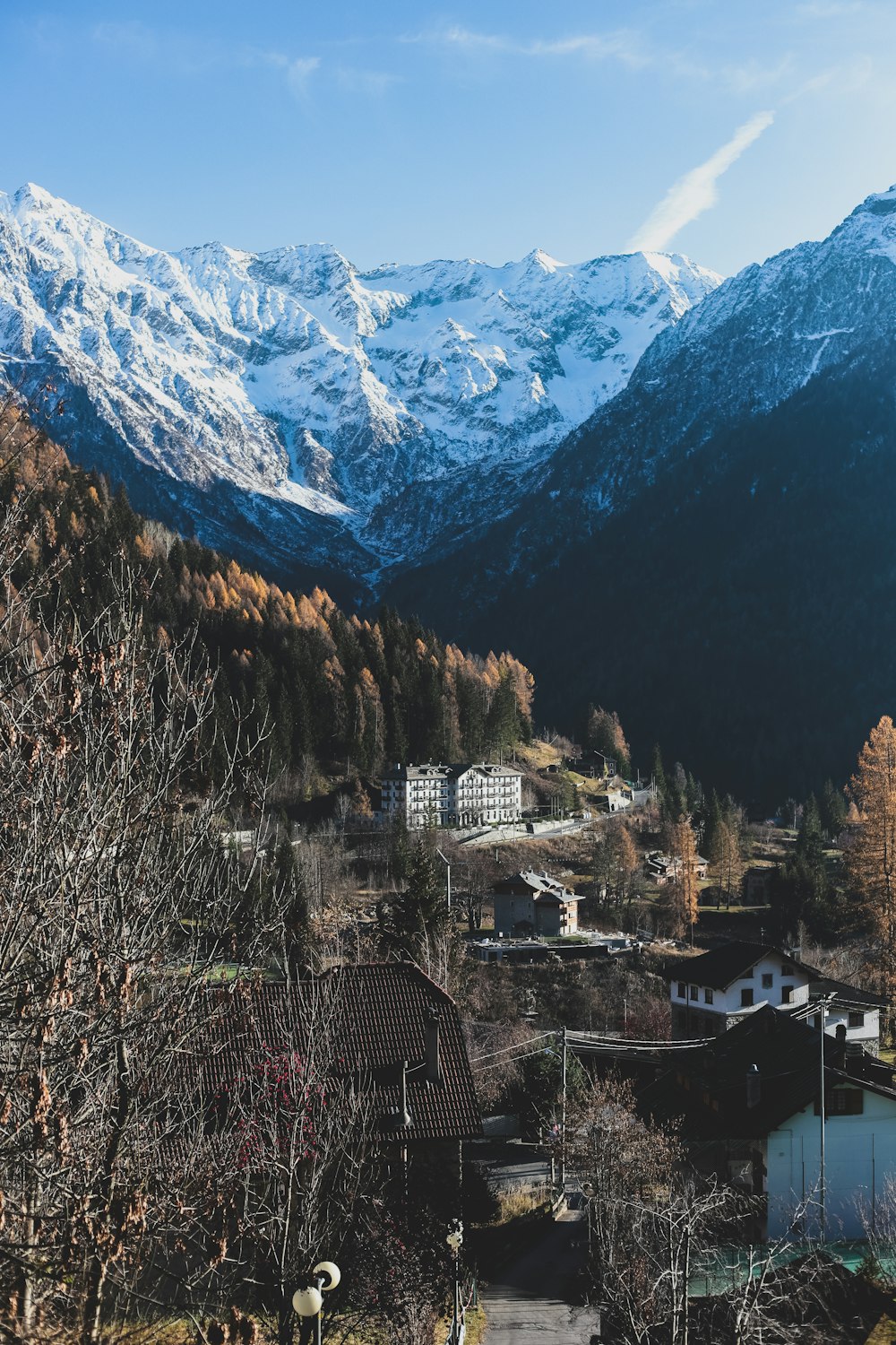 white and brown concrete buildings near green mountains during daytime