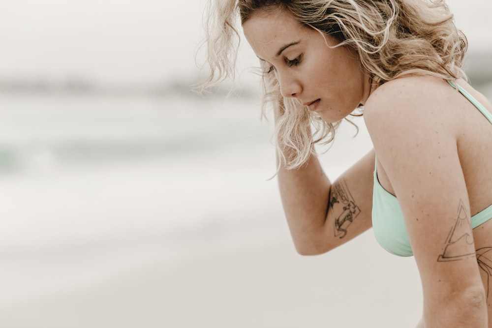 woman in teal tank top