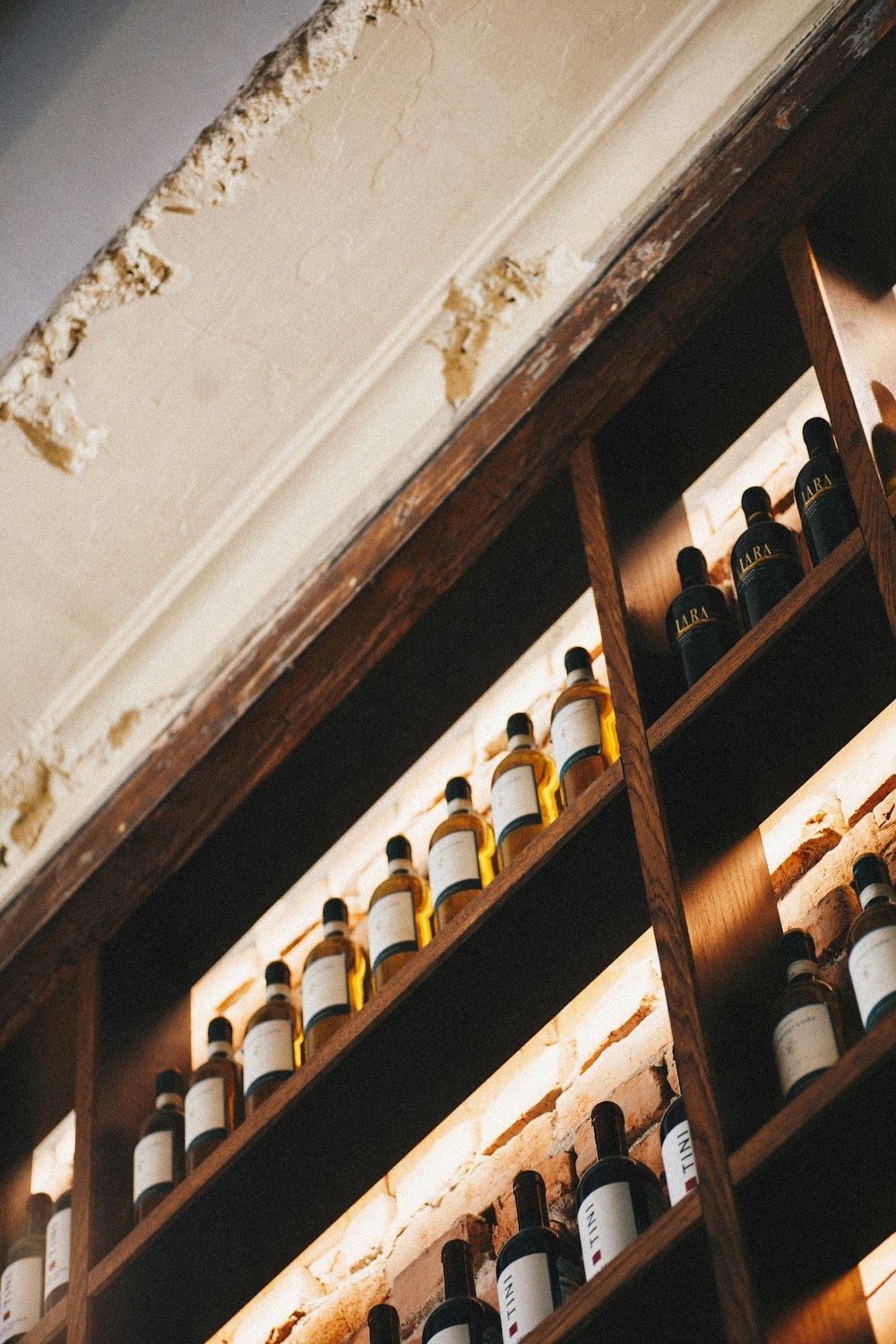 bottles on brown wooden shelf