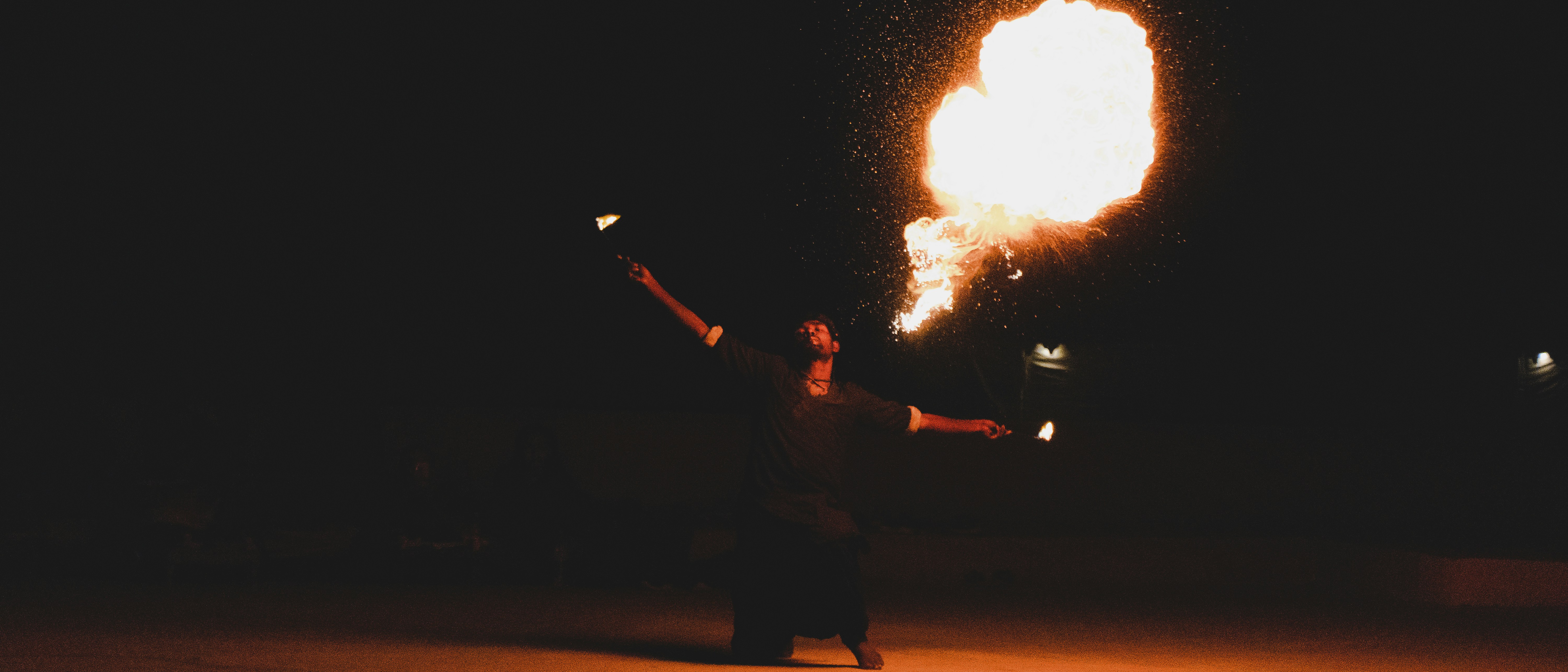 man in black jacket holding fire