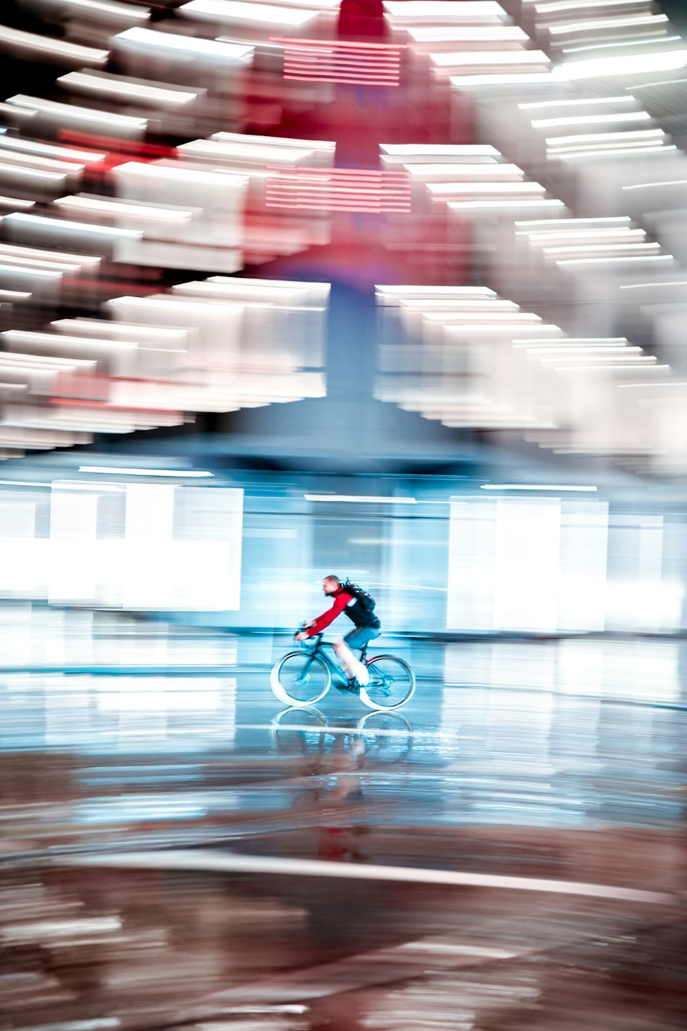 man in red jacket riding bicycle