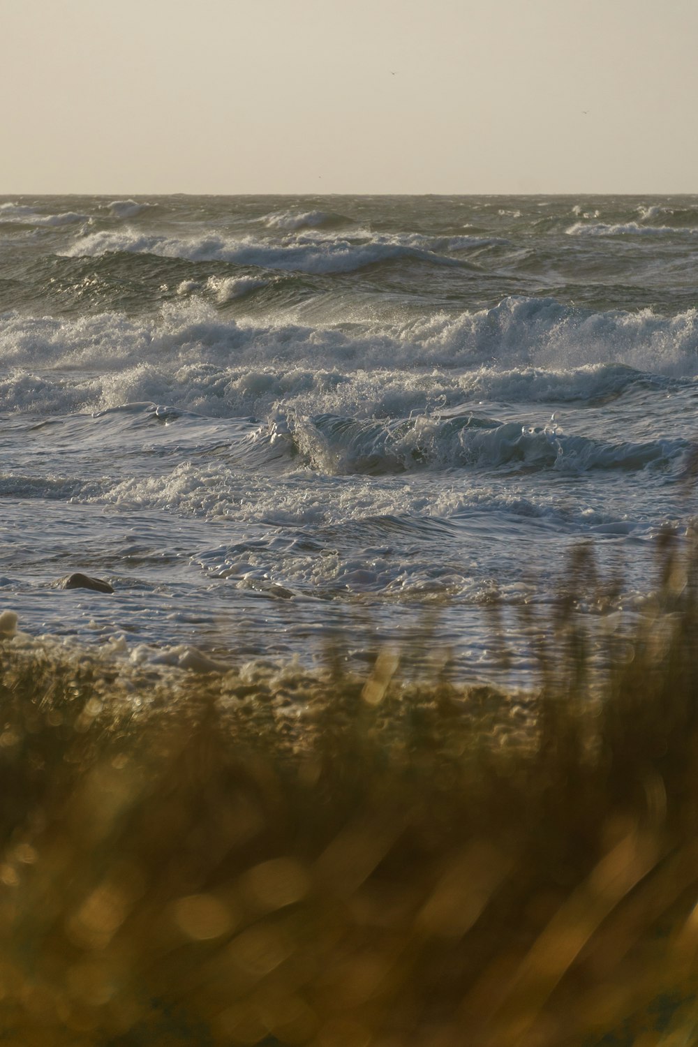 ocean waves crashing on shore during daytime