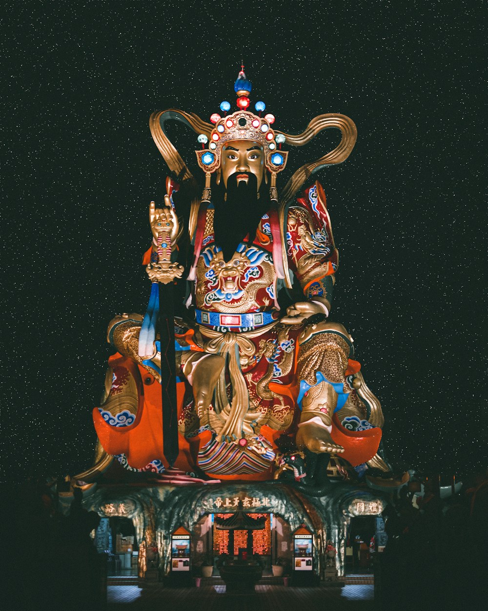 Figurilla de deidad hindú dorada y roja