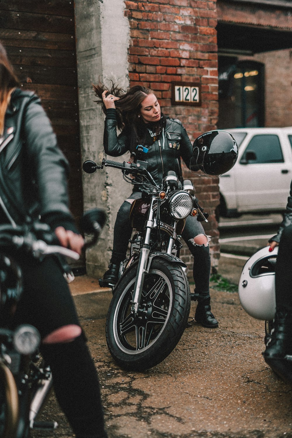 man in black leather jacket riding on motorcycle