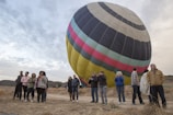 A panoramic view of the launch site with students gathered around a large weather balloon.