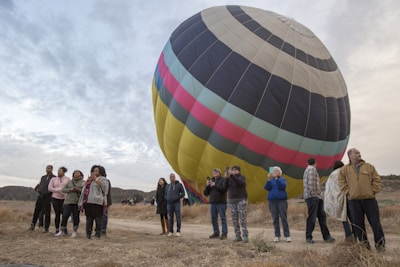 A panoramic view of the launch site with students gathered around a large weather balloon.