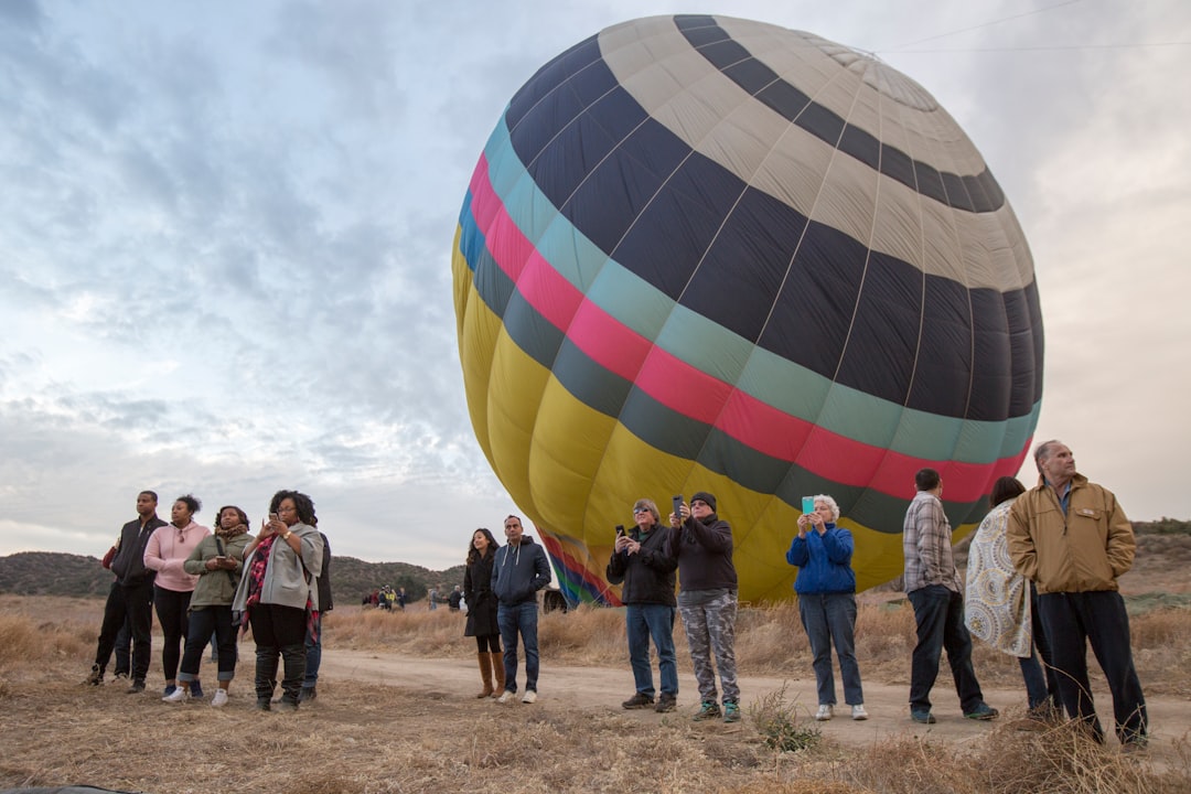 people standing near hot air balloons during daytime