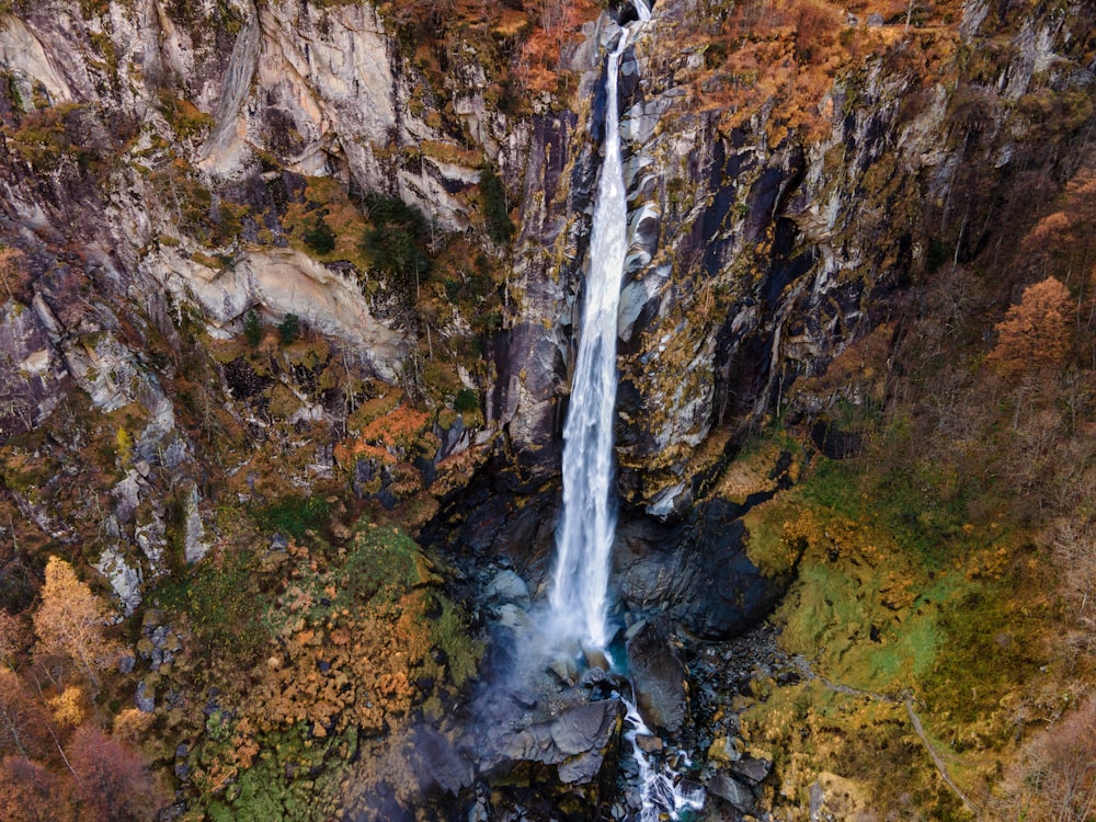 waterfalls in brown rocky mountain during daytime