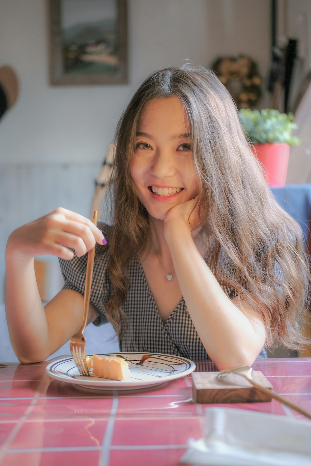 woman in black tank top holding fork