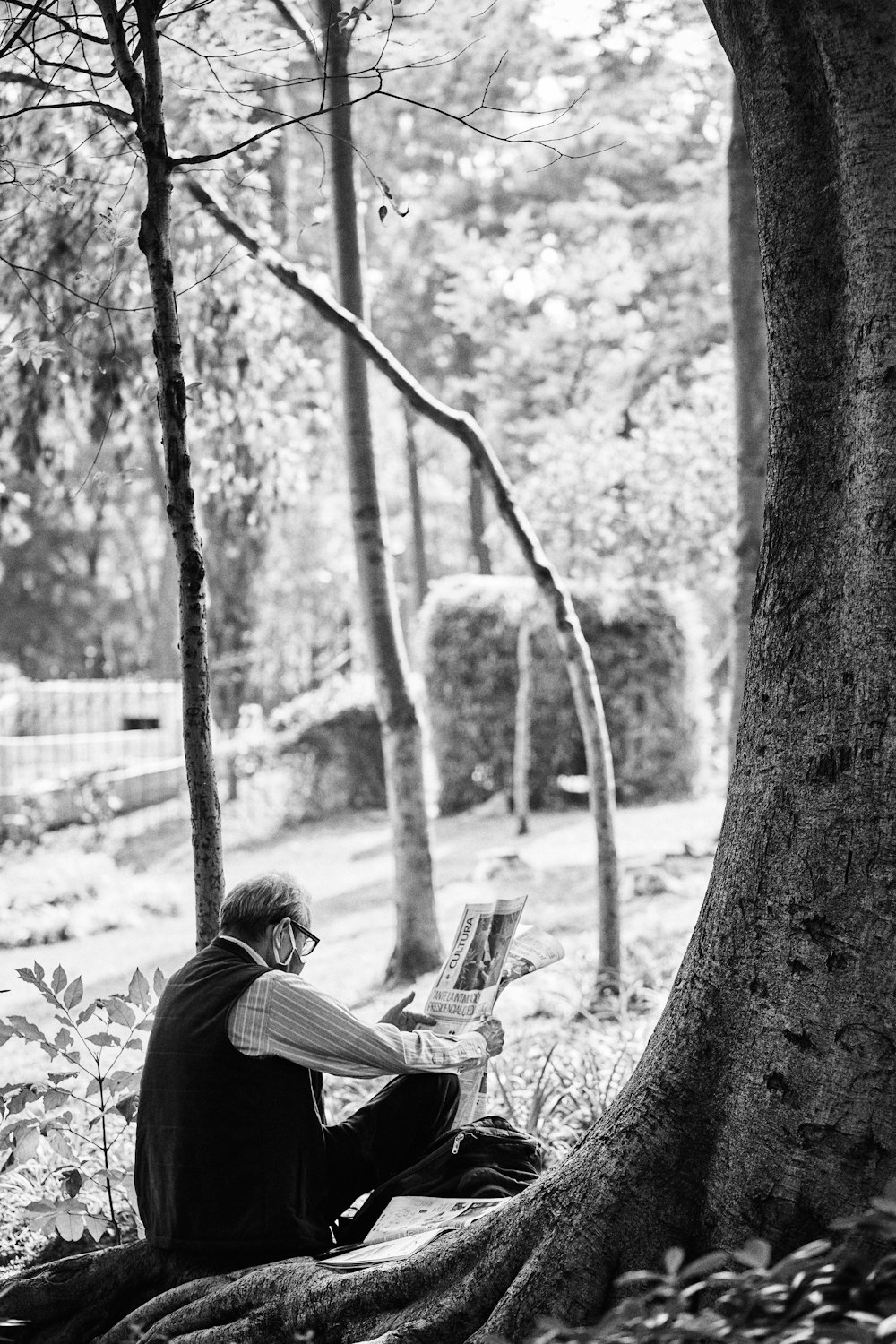 grayscale photo of woman sitting on chair