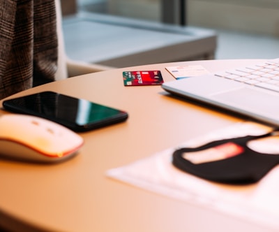 black and orange cordless computer mouse on white table