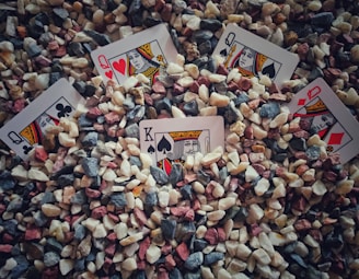 heart of ace playing card on gray and brown stones