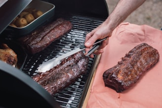 person slicing meat on tray