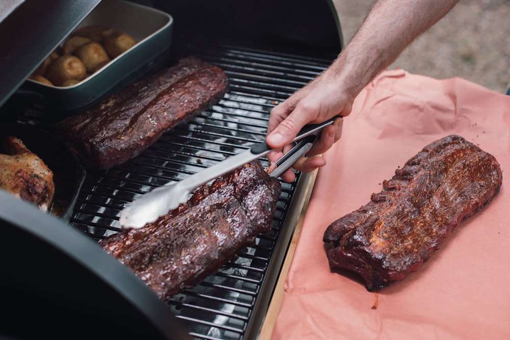 person slicing meat on tray