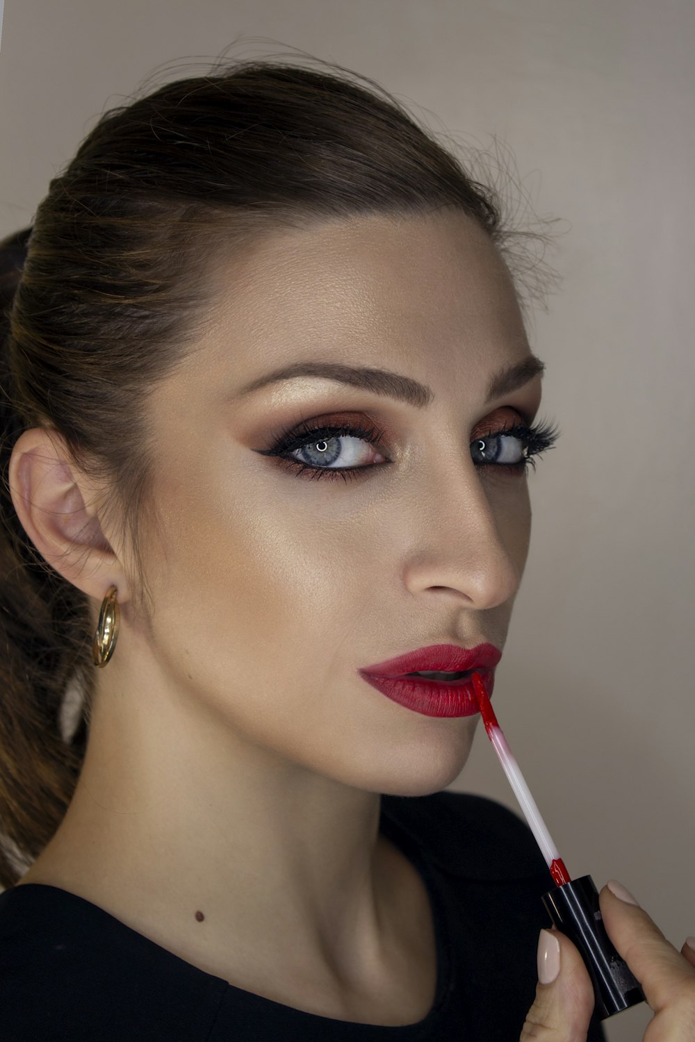 woman with red lipstick and black mascara