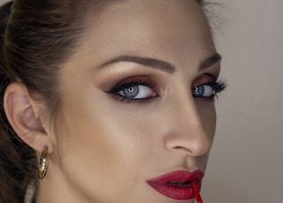 woman with red lipstick and black mascara