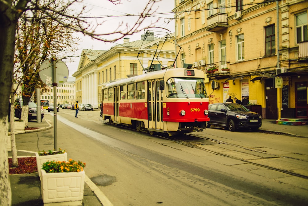 red and white tram on road during daytime