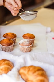 three cupcakes on white tissue paper