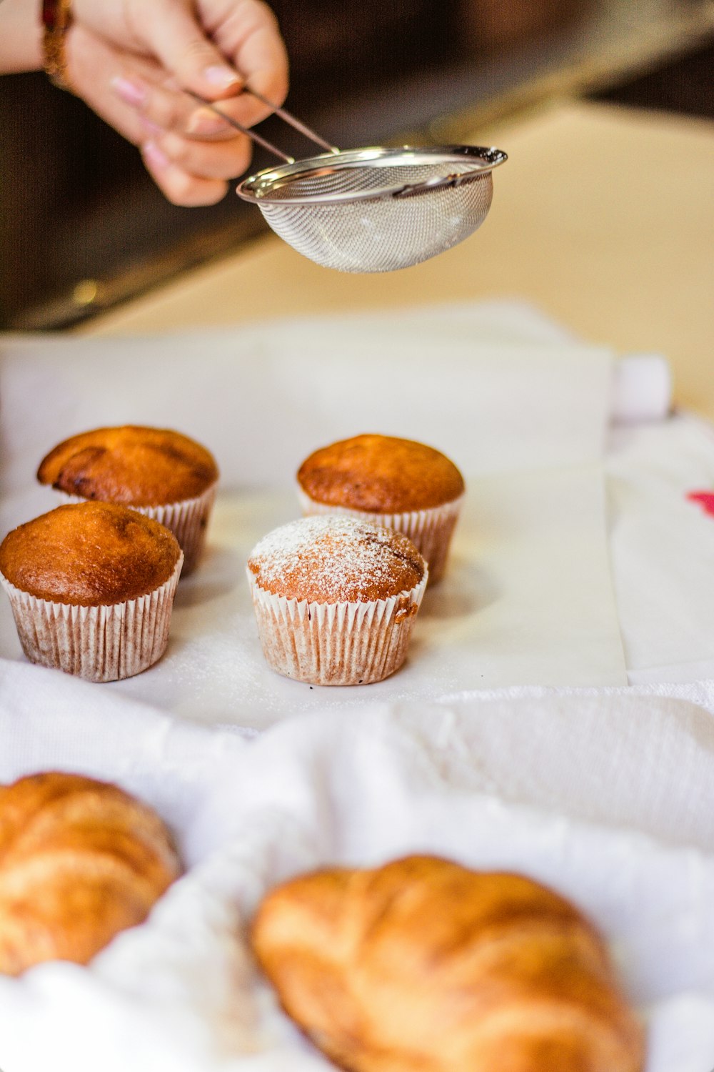 three cupcakes on white tissue paper