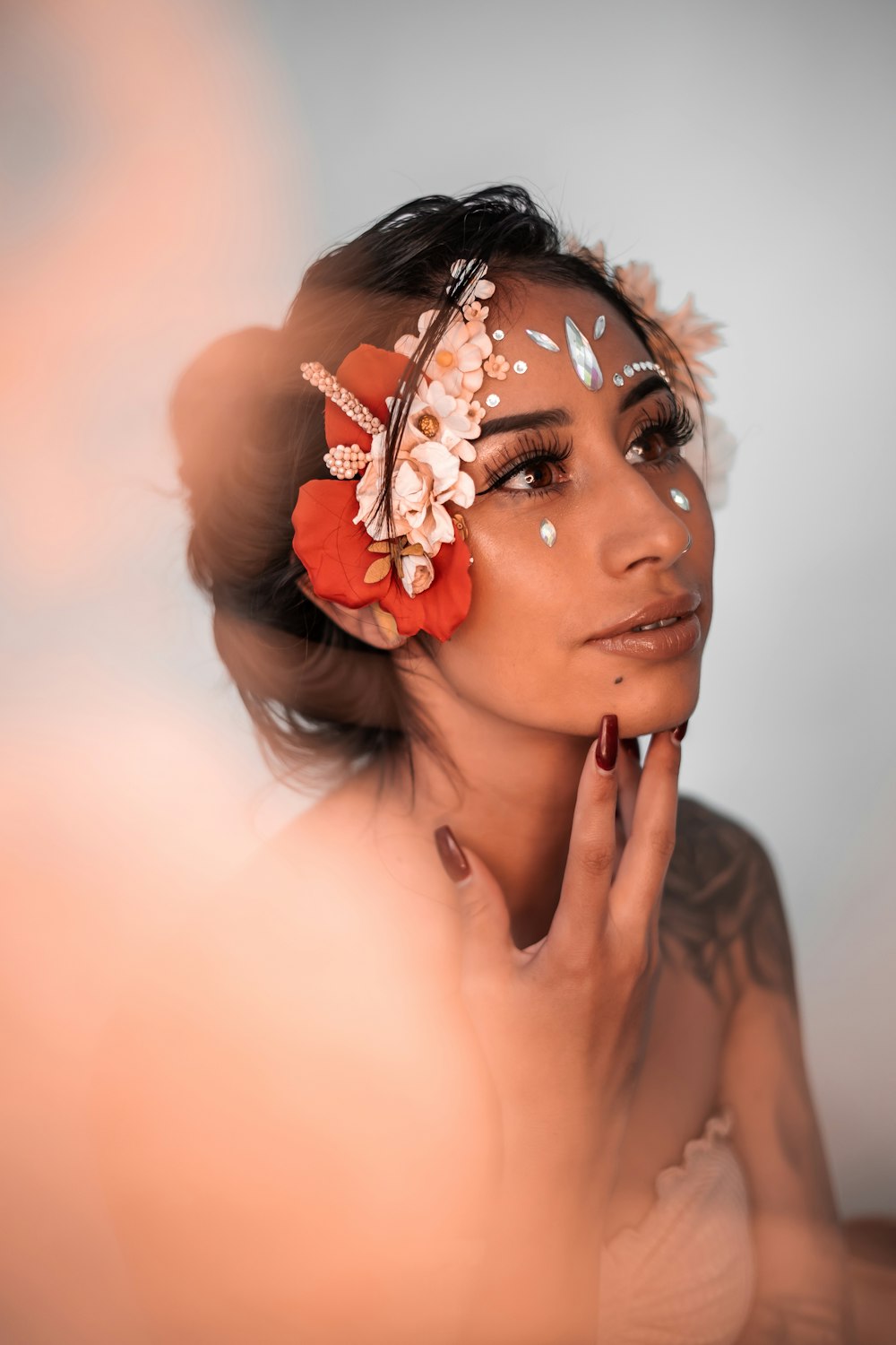 woman with white and red flower on her face