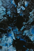 An abstract print swirling with charcoal grays and deep blues, evoking the flow of a blues melody.
