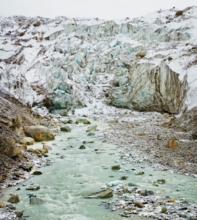 rocky river between rocky mountains during daytime