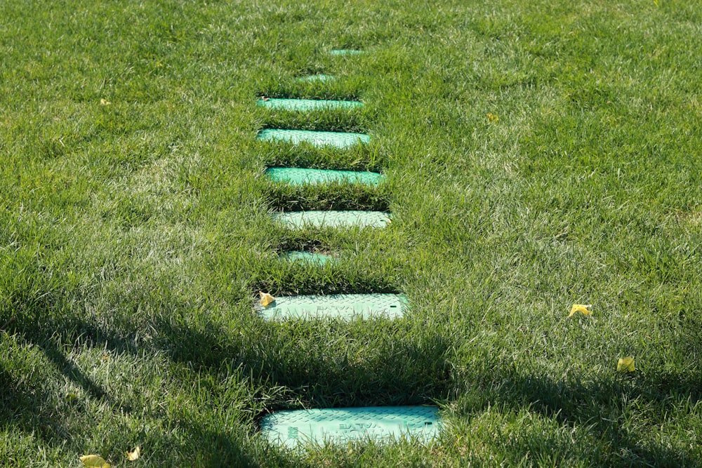 blue and white concrete blocks on green grass field