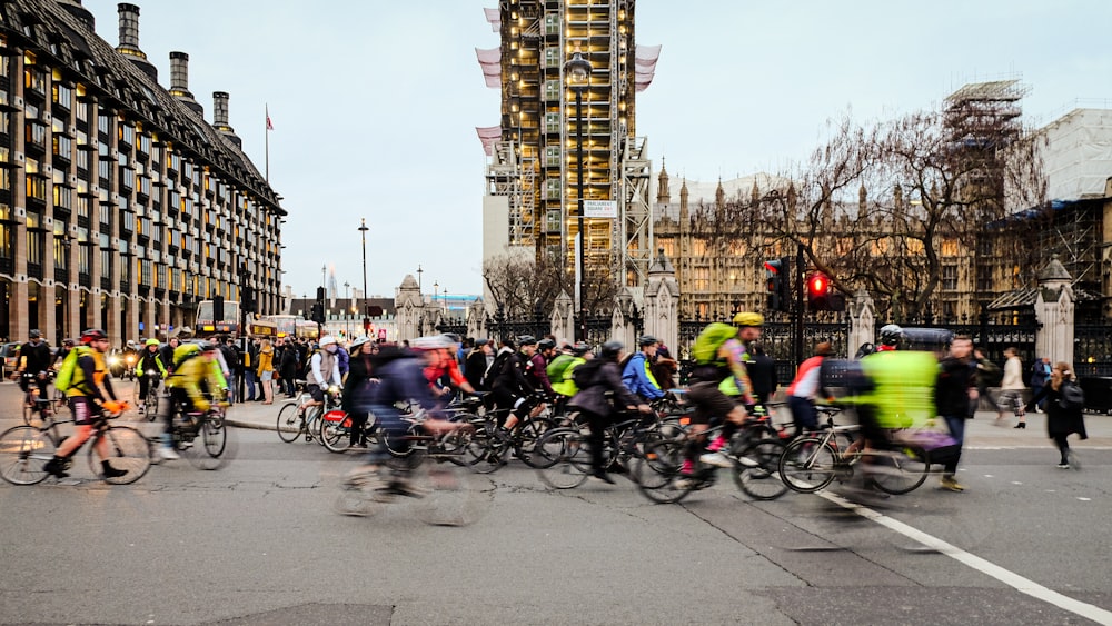 people riding bicycles on road during daytime