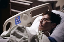 man in blue hoodie wearing eyeglasses