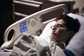 man in blue hoodie wearing eyeglasses