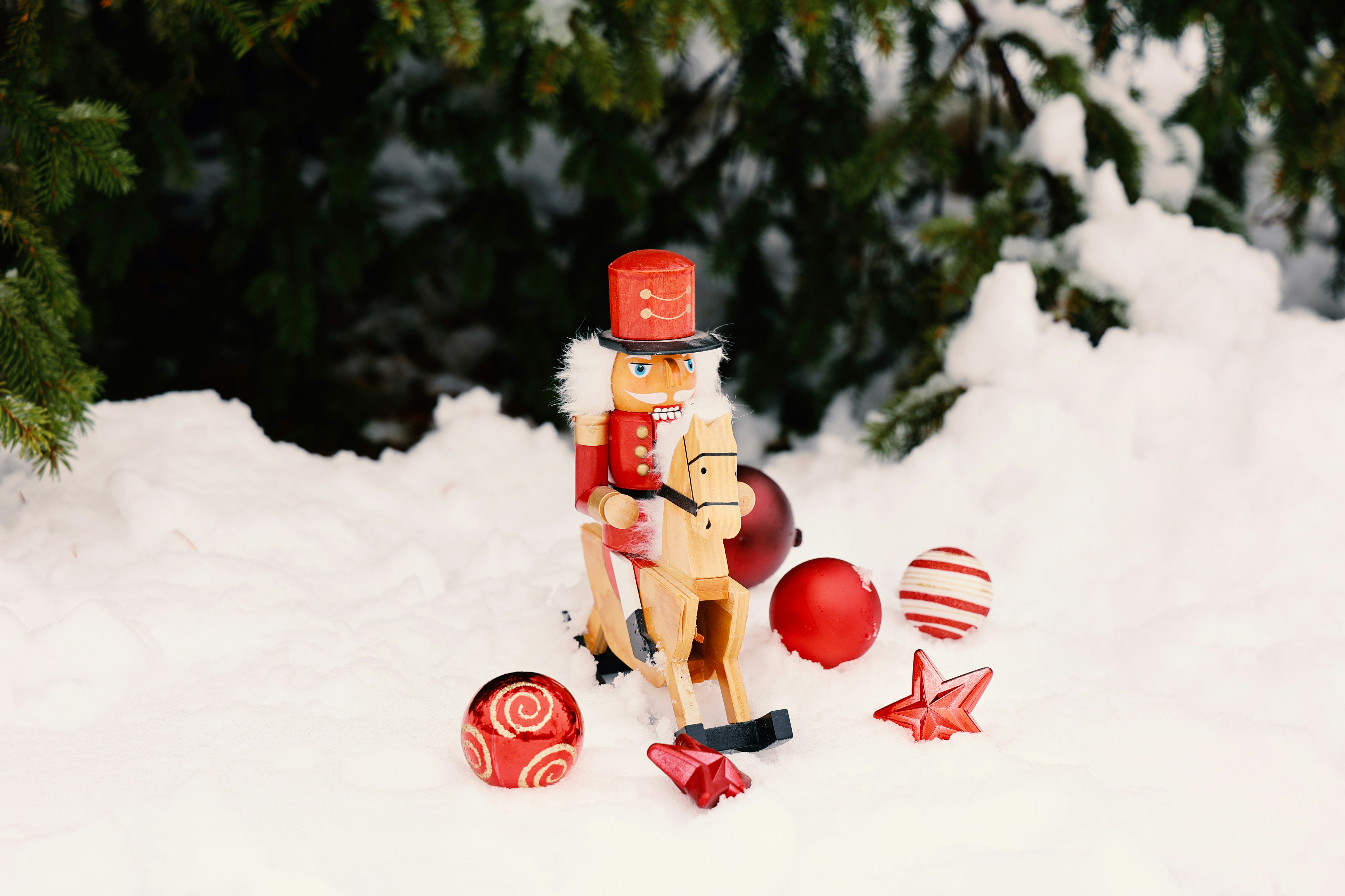 red and brown robot toy on snow nutcracker teams background