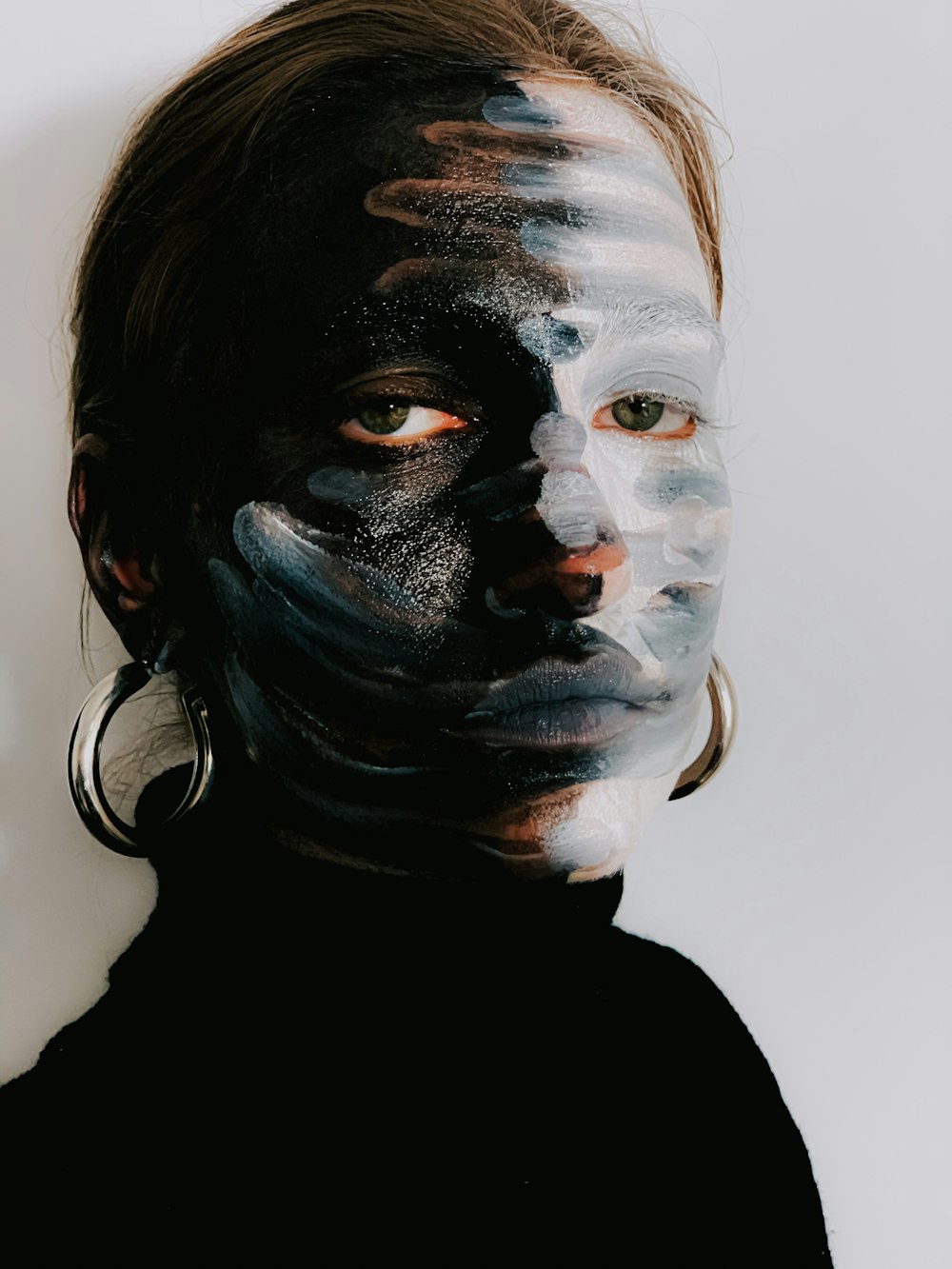 man in black crew neck shirt with white and black face paint