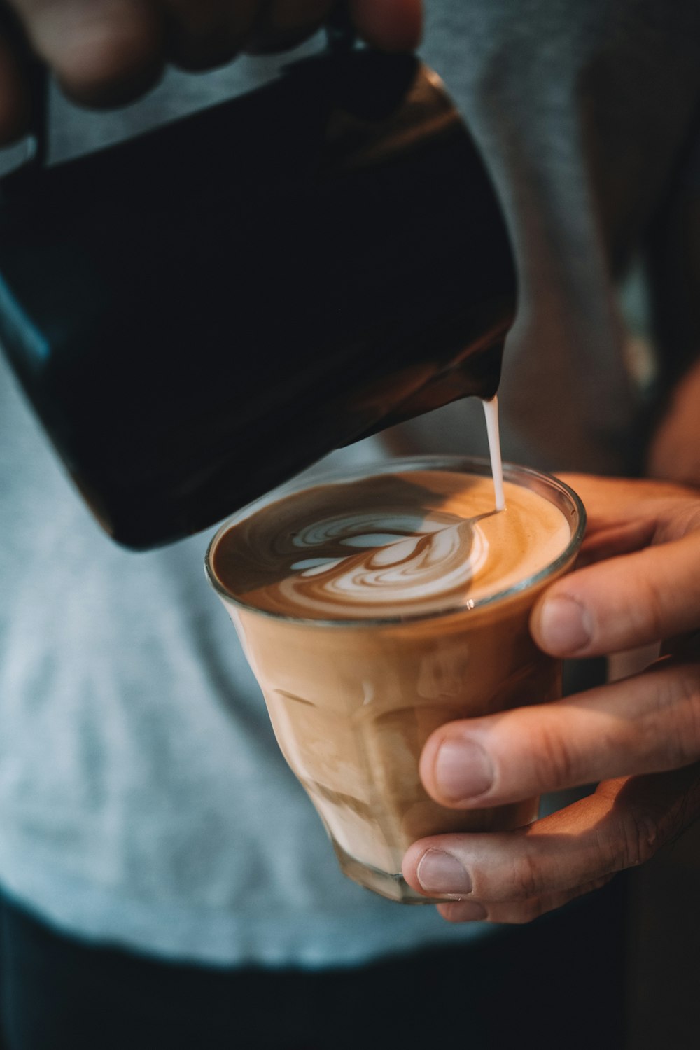 person holding white ceramic mug with coffee