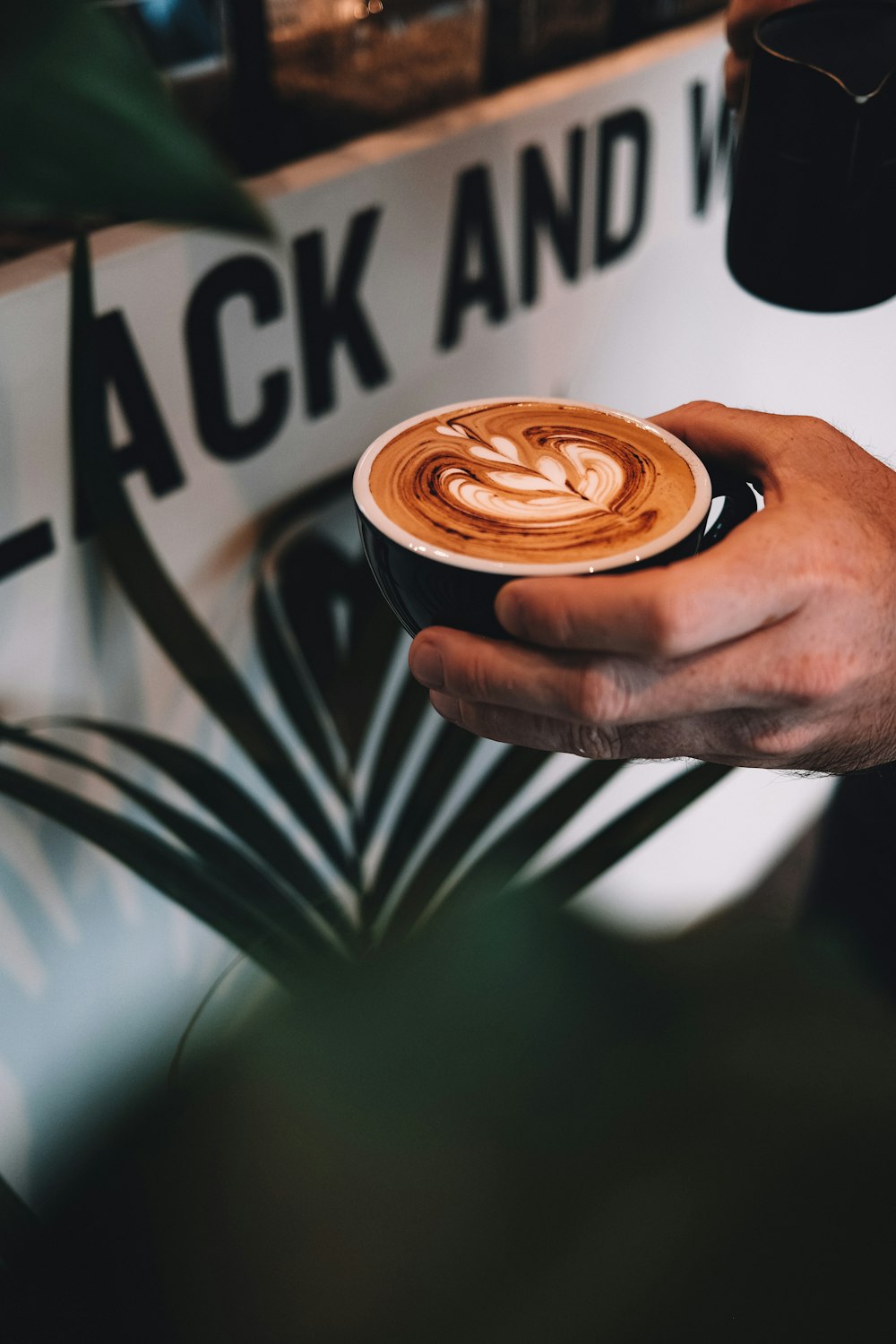 person holding cup of coffee