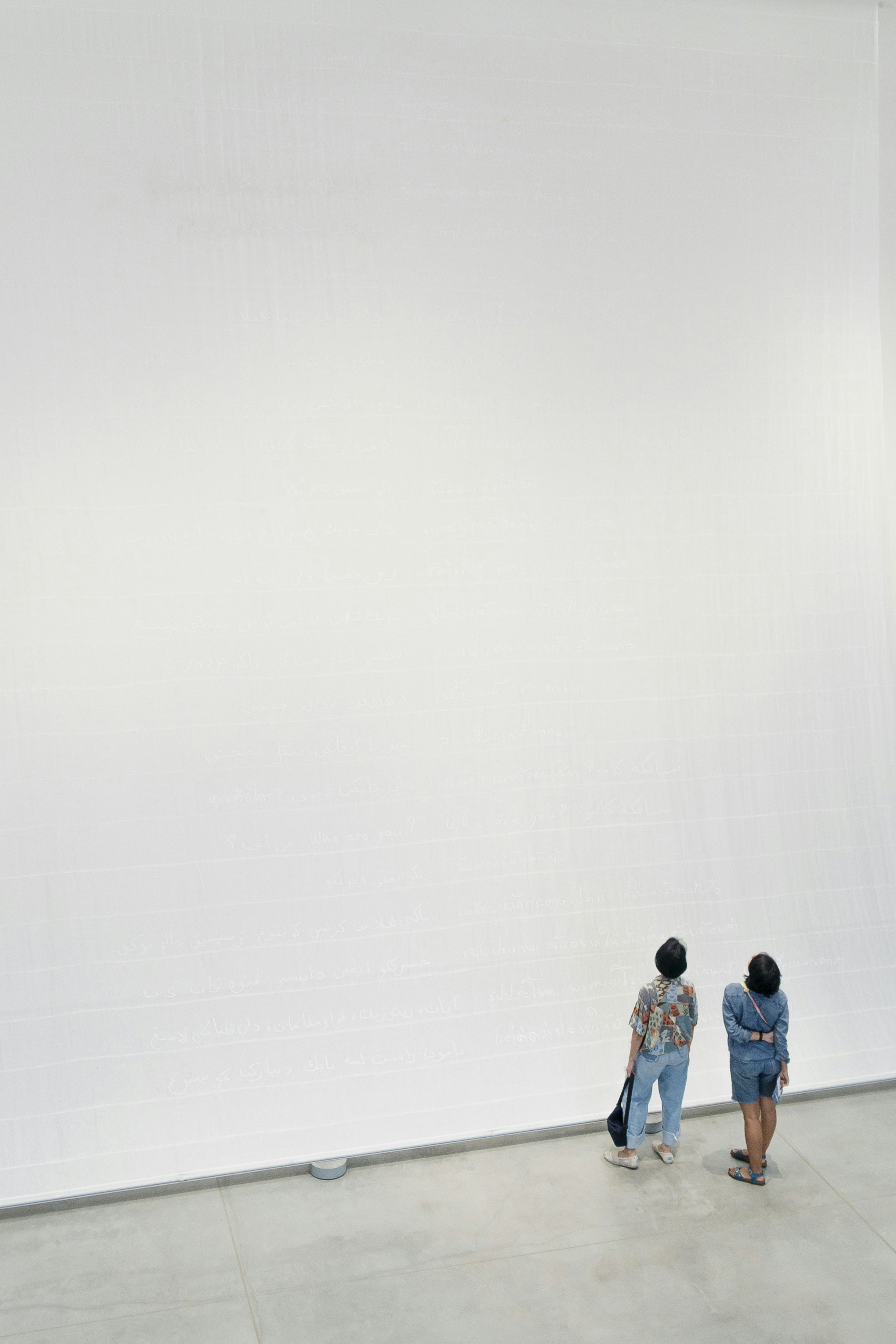 3-men-and-2-women-standing-on-white-wall
