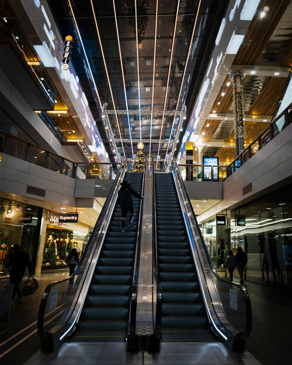 people walking on escalator inside building