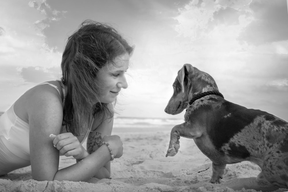 grayscale photo of woman holding dog