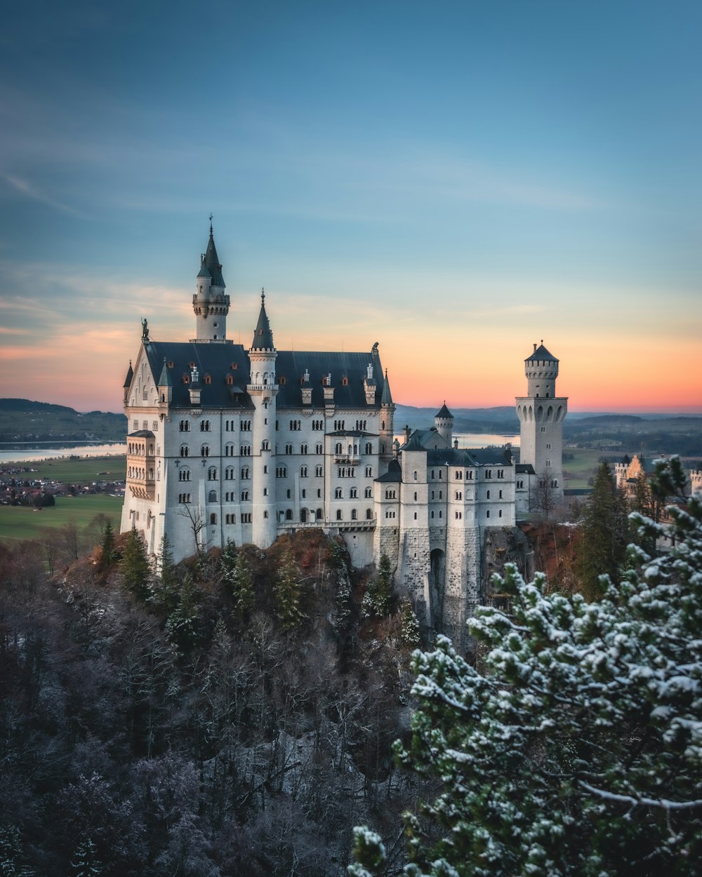 white and black castle on top of hill